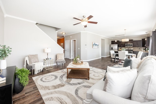 living room with ceiling fan, ornamental molding, and dark hardwood / wood-style flooring