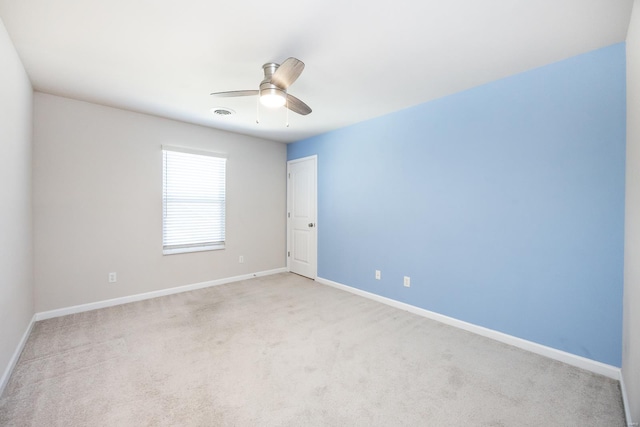 carpeted spare room with ceiling fan