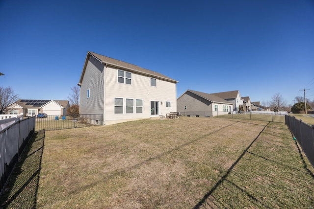 rear view of property with a lawn