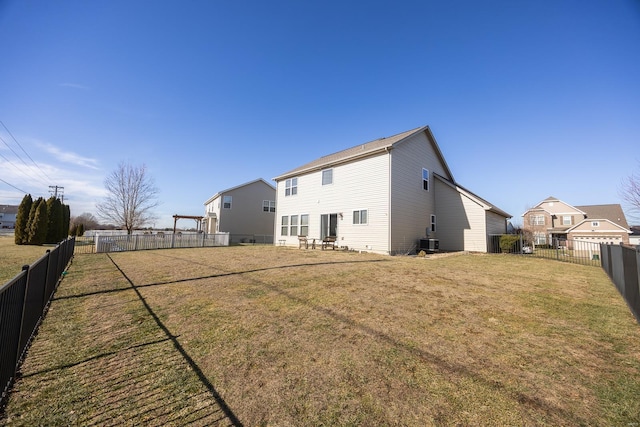 back of house with a yard and central AC