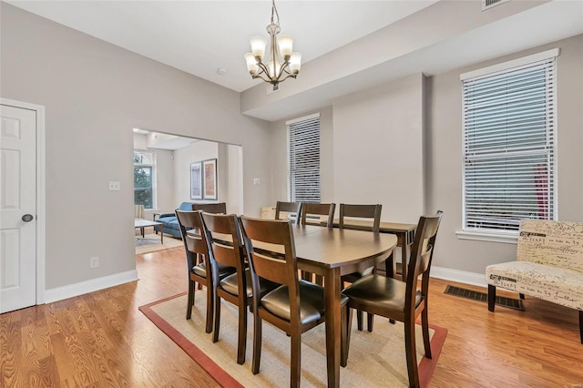 dining room with a notable chandelier and light hardwood / wood-style flooring