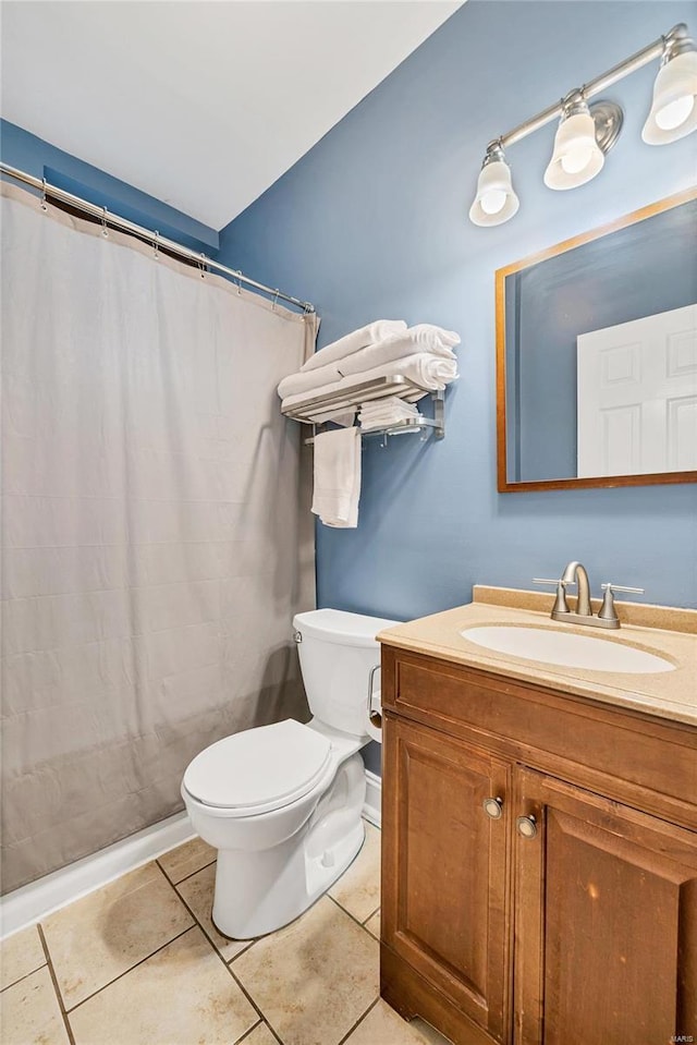 bathroom featuring tile patterned flooring, vanity, and toilet