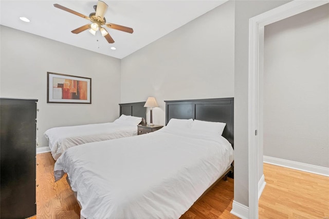 bedroom with vaulted ceiling, ceiling fan, and hardwood / wood-style floors