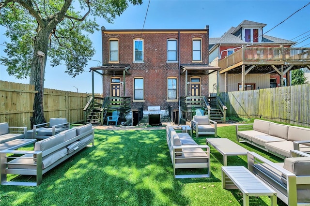 rear view of house with an outdoor living space and a yard