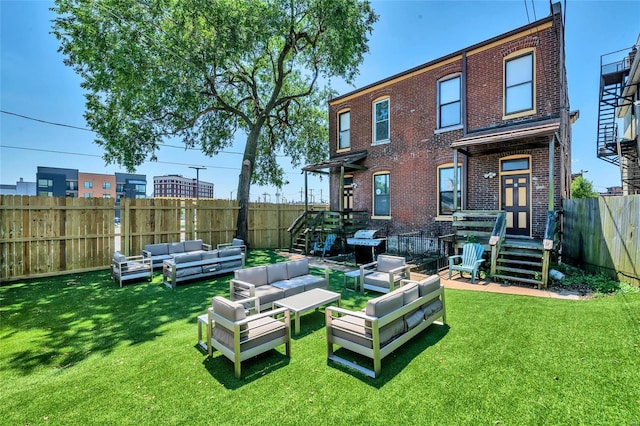 rear view of house with a yard and an outdoor hangout area