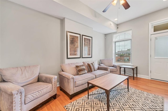 living room featuring ceiling fan and light wood-type flooring