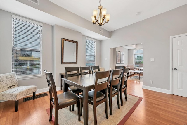 dining space featuring a notable chandelier and light hardwood / wood-style flooring