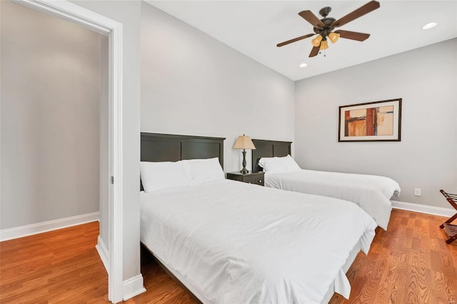 bedroom with wood-type flooring and ceiling fan