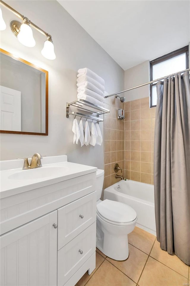 full bathroom featuring toilet, vanity, tile patterned floors, and shower / tub combo with curtain