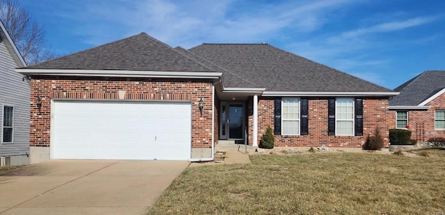 view of front of home featuring a garage and a front yard