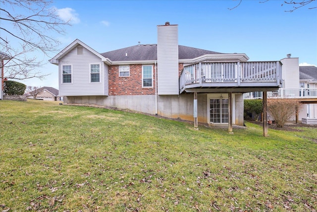 back of property with a lawn and a deck