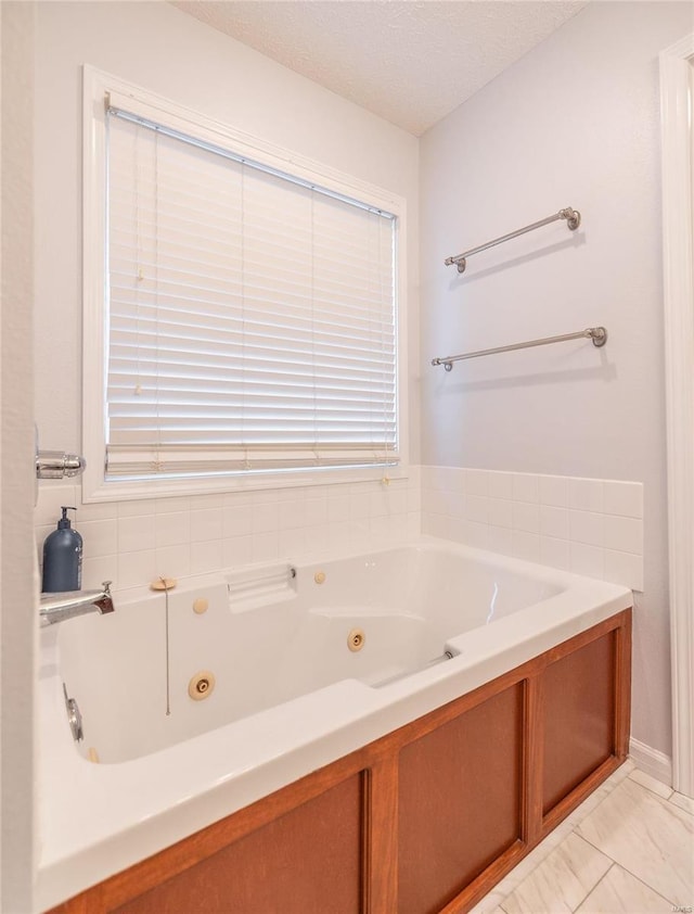 bathroom featuring a bathtub and a textured ceiling