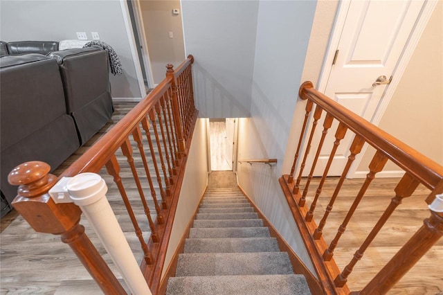 stairway featuring wood-type flooring