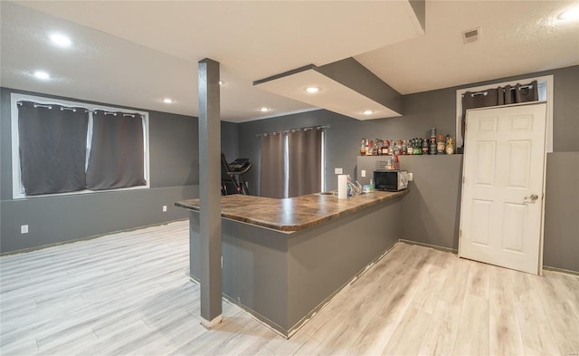 kitchen featuring light hardwood / wood-style floors and kitchen peninsula