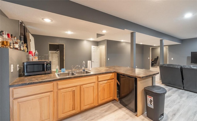 kitchen featuring sink, light hardwood / wood-style flooring, fridge, and kitchen peninsula