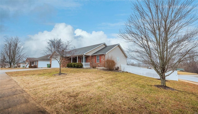 single story home featuring a garage, a front lawn, and covered porch