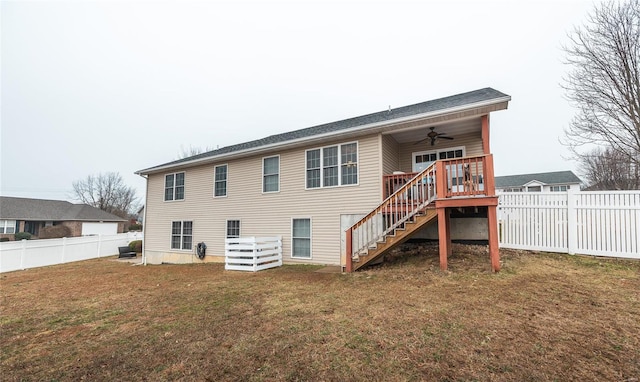 back of house with a wooden deck, ceiling fan, and a lawn