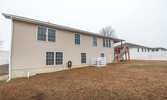 rear view of property featuring a lawn