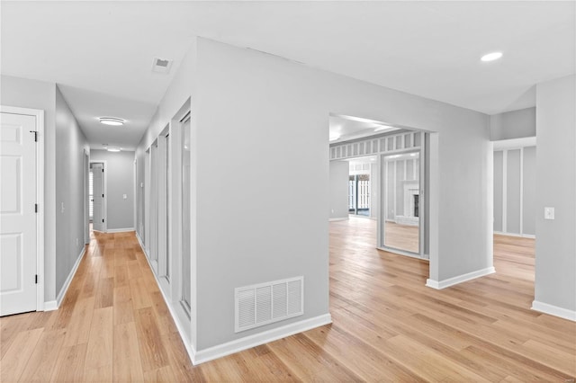 hall with light hardwood / wood-style flooring