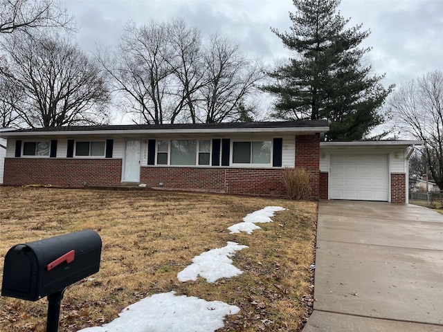 single story home with a garage and a front lawn