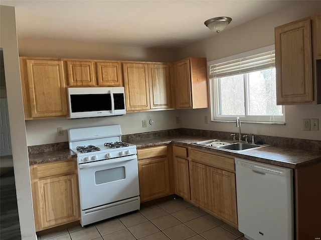 kitchen featuring sink, white appliances, and light tile patterned flooring