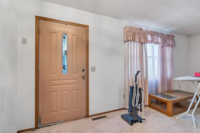 entryway featuring light colored carpet