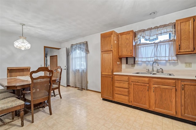 kitchen featuring sink and decorative light fixtures