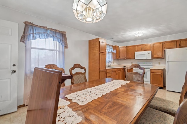 dining room featuring an inviting chandelier and sink