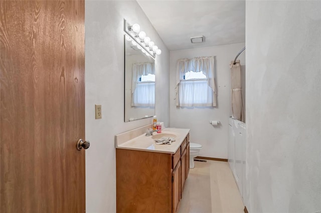 bathroom featuring vanity and toilet