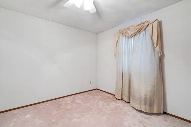 unfurnished room featuring light carpet and ceiling fan