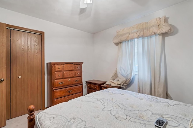 bedroom featuring ceiling fan, carpet, and a closet