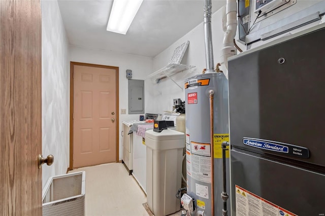 laundry room with heating unit, gas water heater, electric panel, and washer and dryer