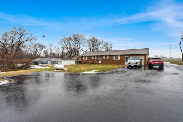 single story home with a garage and a front yard