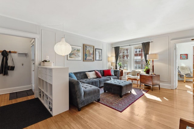 living room featuring light wood-style flooring and baseboards