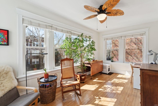 sunroom / solarium featuring ceiling fan