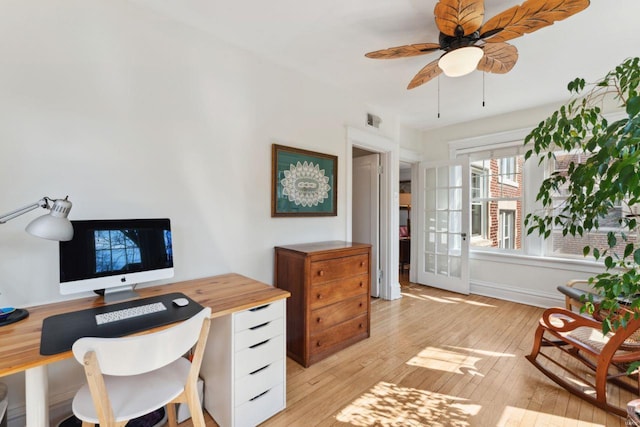 office area featuring french doors, visible vents, light wood-style flooring, ceiling fan, and baseboards