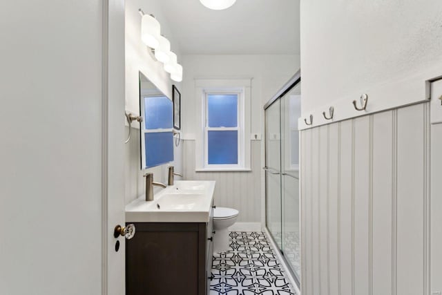 full bathroom featuring a stall shower, tile patterned flooring, vanity, and toilet