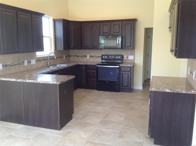 kitchen featuring backsplash, dark brown cabinetry, sink, and black appliances