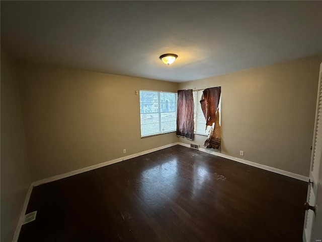 unfurnished room with wood-type flooring