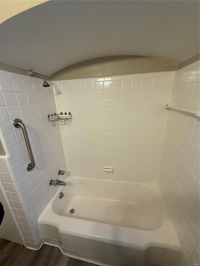 bathroom with hardwood / wood-style flooring and tiled shower / bath combo
