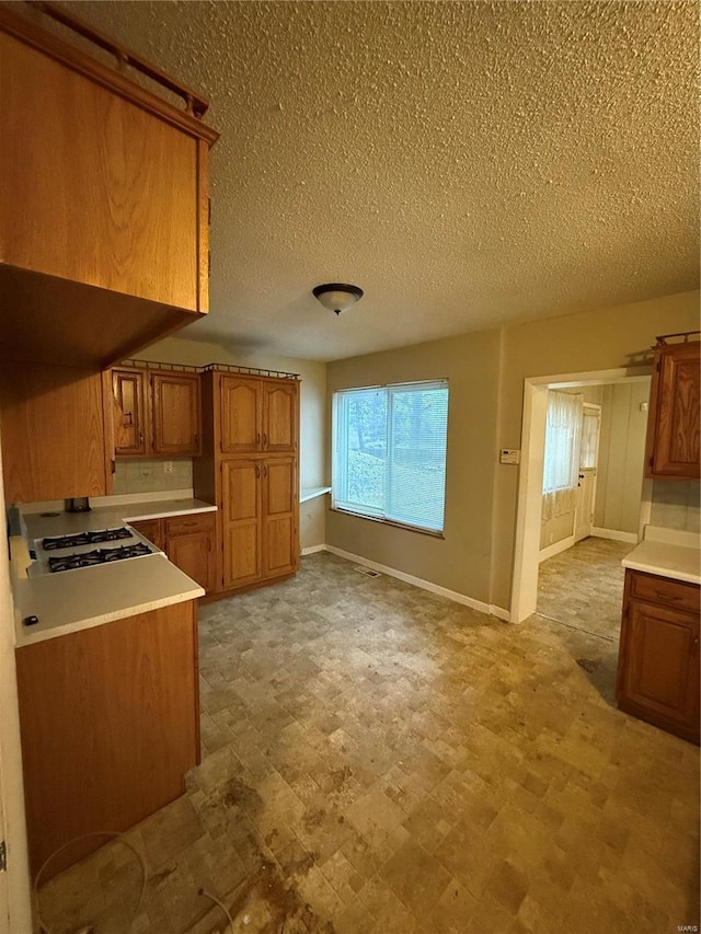 kitchen featuring gas stovetop and a textured ceiling