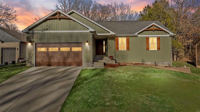 view of front of home featuring concrete driveway, roof with shingles, an attached garage, and a front yard