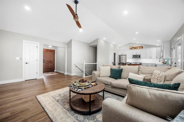 living area with recessed lighting, vaulted ceiling, baseboards, and wood finished floors