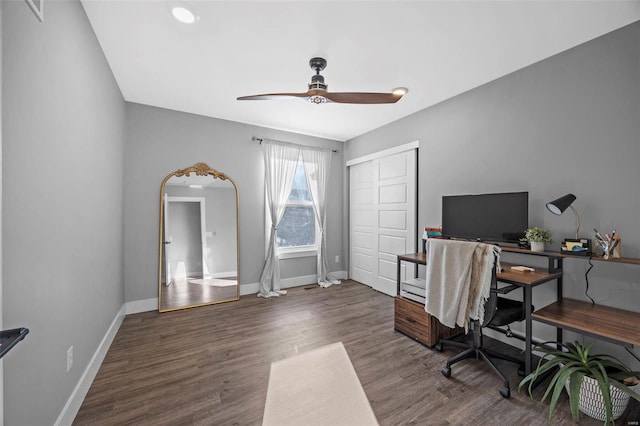 office space with ceiling fan, arched walkways, wood finished floors, and baseboards