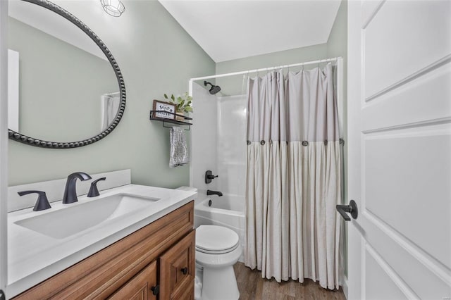 bathroom with shower / bath combo, vanity, toilet, and wood finished floors