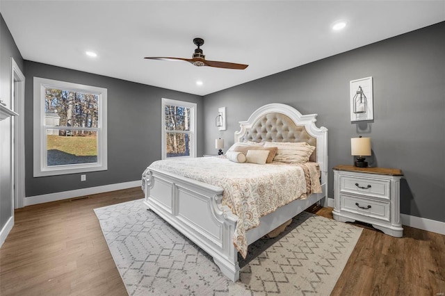 bedroom with dark wood-type flooring, recessed lighting, and baseboards