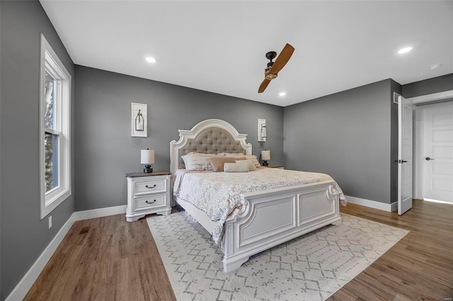 bedroom featuring ceiling fan, baseboards, wood finished floors, and recessed lighting