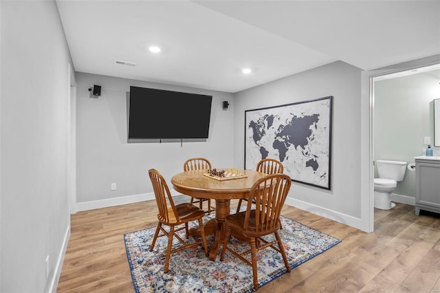 dining space with baseboards, recessed lighting, visible vents, and light wood-style floors