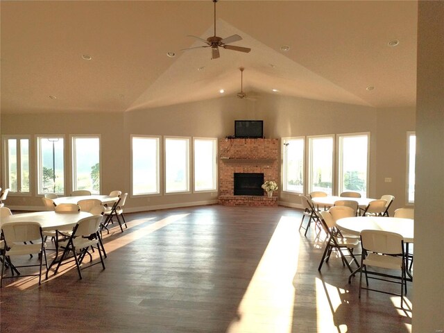 living room with plenty of natural light, wood finished floors, and a brick fireplace