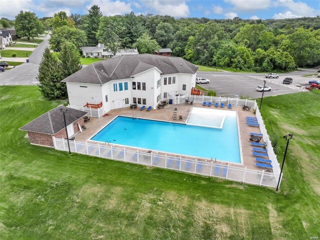 view of swimming pool with fence, a fenced in pool, and a yard